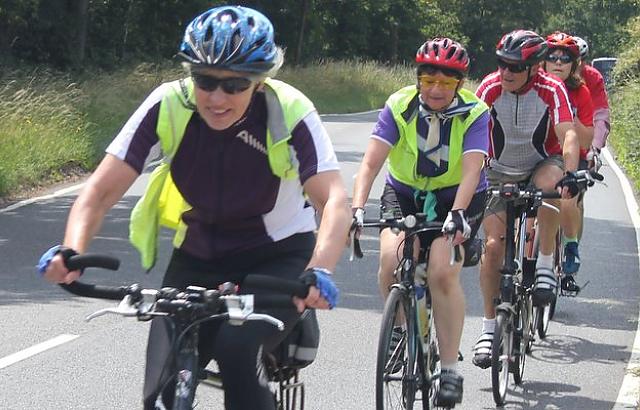 Female cyclist leading a small group