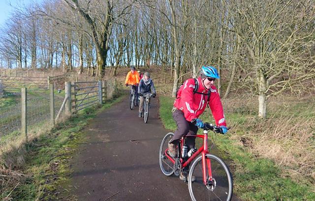 Cyclists enjoying a downhill on the traffic free Maiden Bower path.