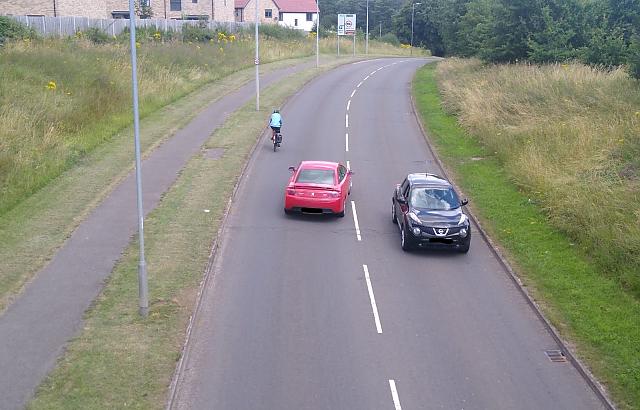 Cyclist on Gresley Way being overtaken by a car