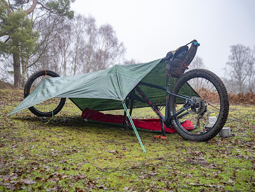 A single-wheel shelter is opened up by using the front wheel as a pole