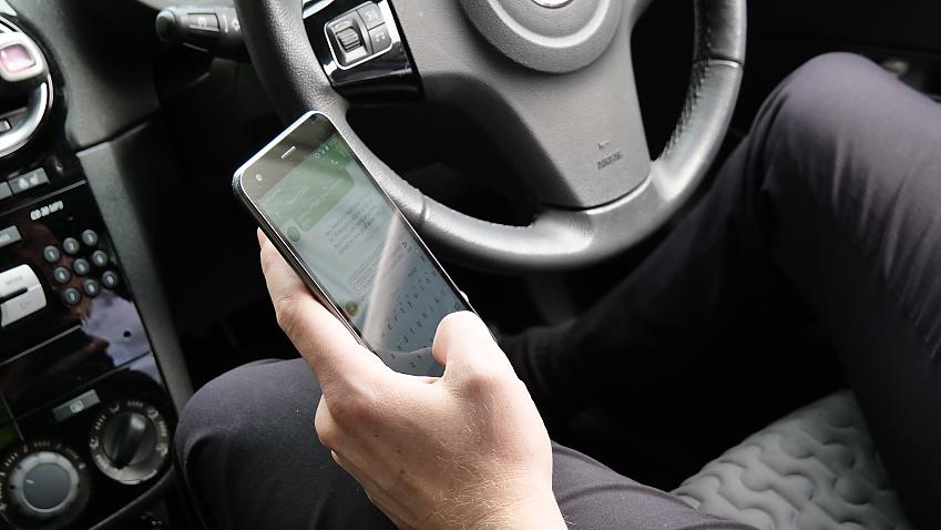 A driver using a mobile phone at the wheel