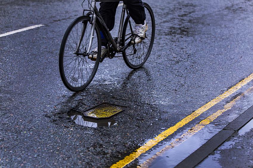 Potholes often form near drains and manhole covers