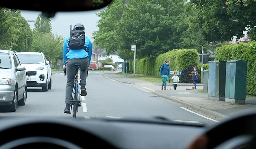 Cyclist riding out from the car-door zone