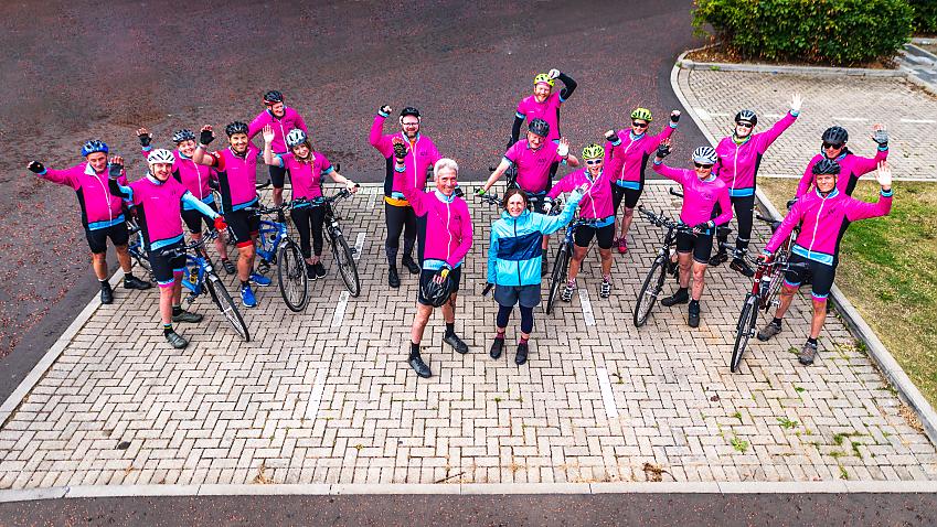 Ken Reid of VIE Velo and Suzanne Forup of Cycling UK standing with a group of riders from VIE Velo with their tandems