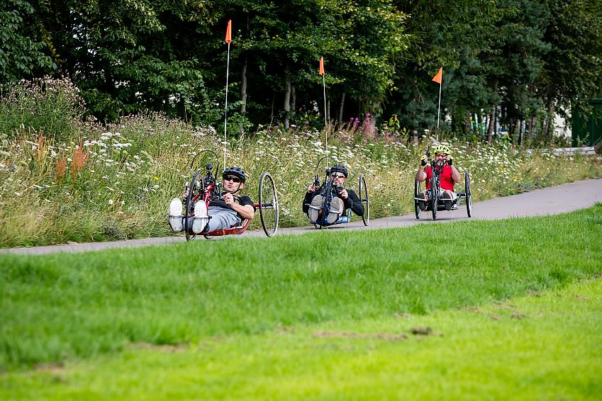 Three handcyclists in the park