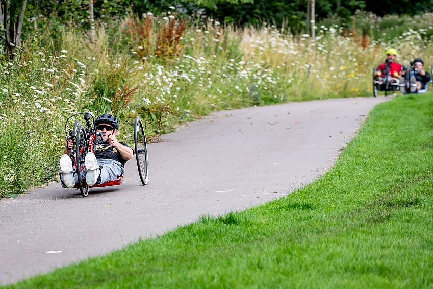 Three handcyclists in the park