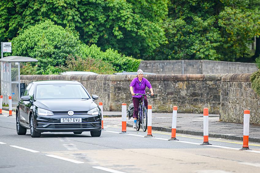 A woman cycling in a separated cycle lane