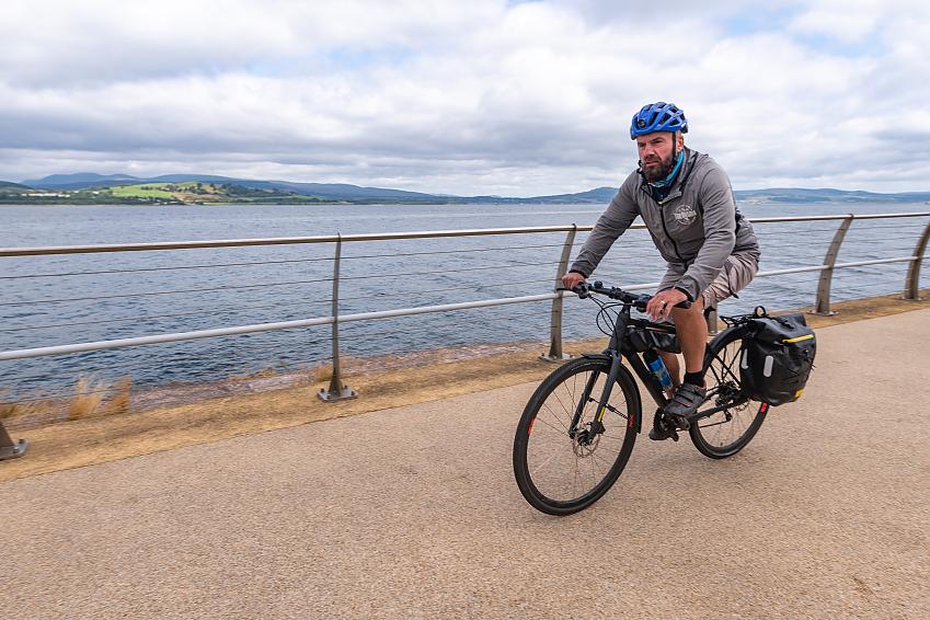 Keith Fergus riding his bike by the water in Gourock