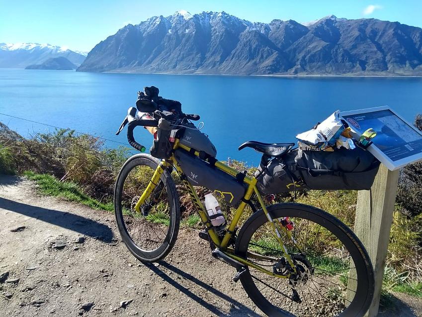 Jenny Graham’s bike with spectacular New Zealand lake and mountains in background