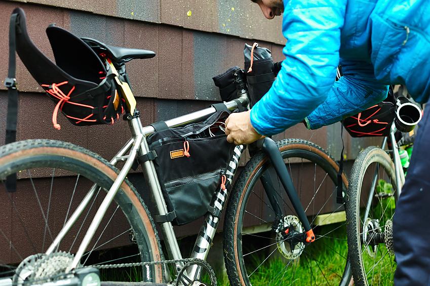 Person attaching bikepacking bags to their bike