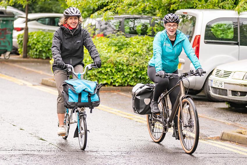 Two women cycling along the streets of Edinburgh