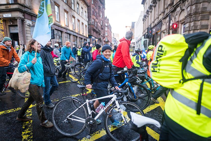 Climate marches push their bikes in a demonstration in Glasgow city centre
