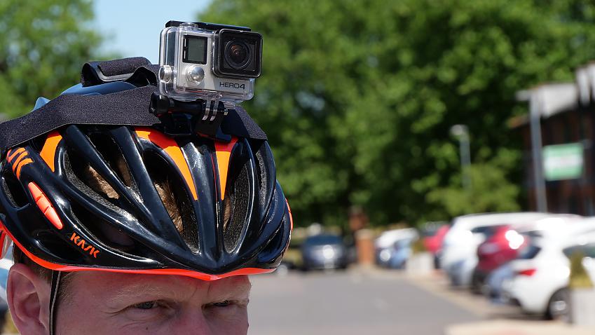 Close up of cyclist wearing a helmet with a headcam