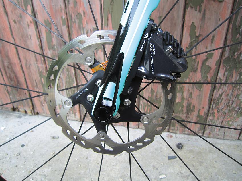 A close-up of the Bianchi's front fork and disc brakes