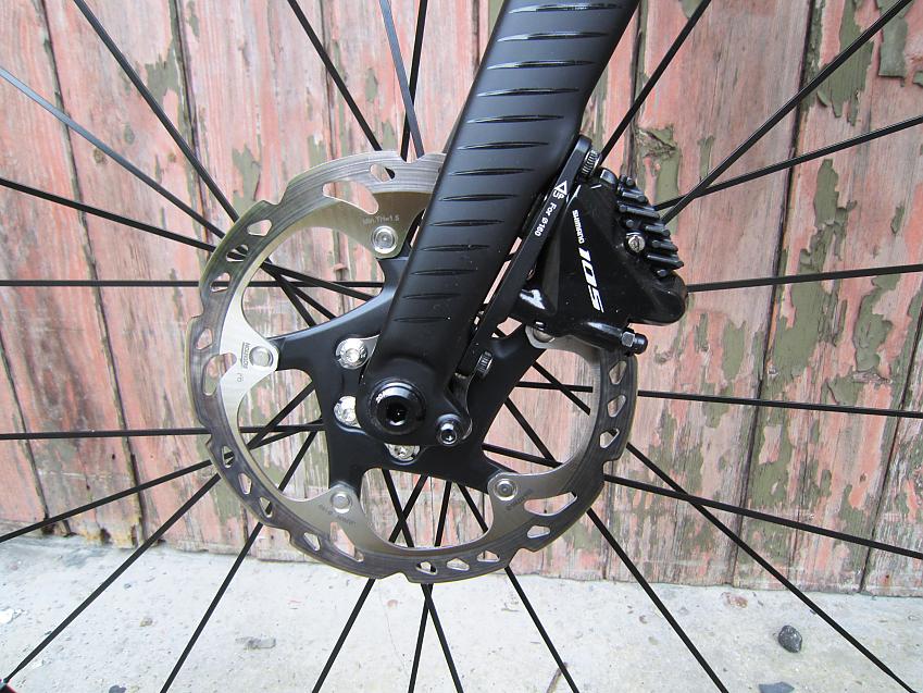 A close-up of the Orbea's front fork and disc brakes