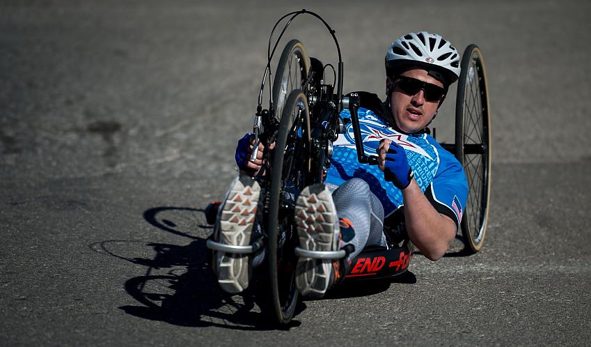 A man racing on a hand cycle