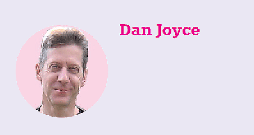 A headshot of Dan Joyce. He is smiling at the camera. His name is written in pink alongside the image, which is in a circle.