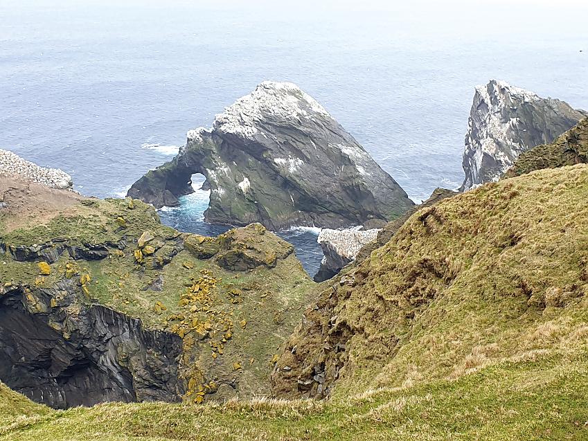 A landscape shot of the island, showing a cliff down to the sea