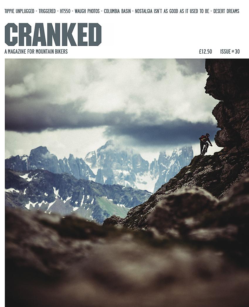 Cranked cover, issue 30, showing a snowy mountain landscape with a person on a mountain bike on the right