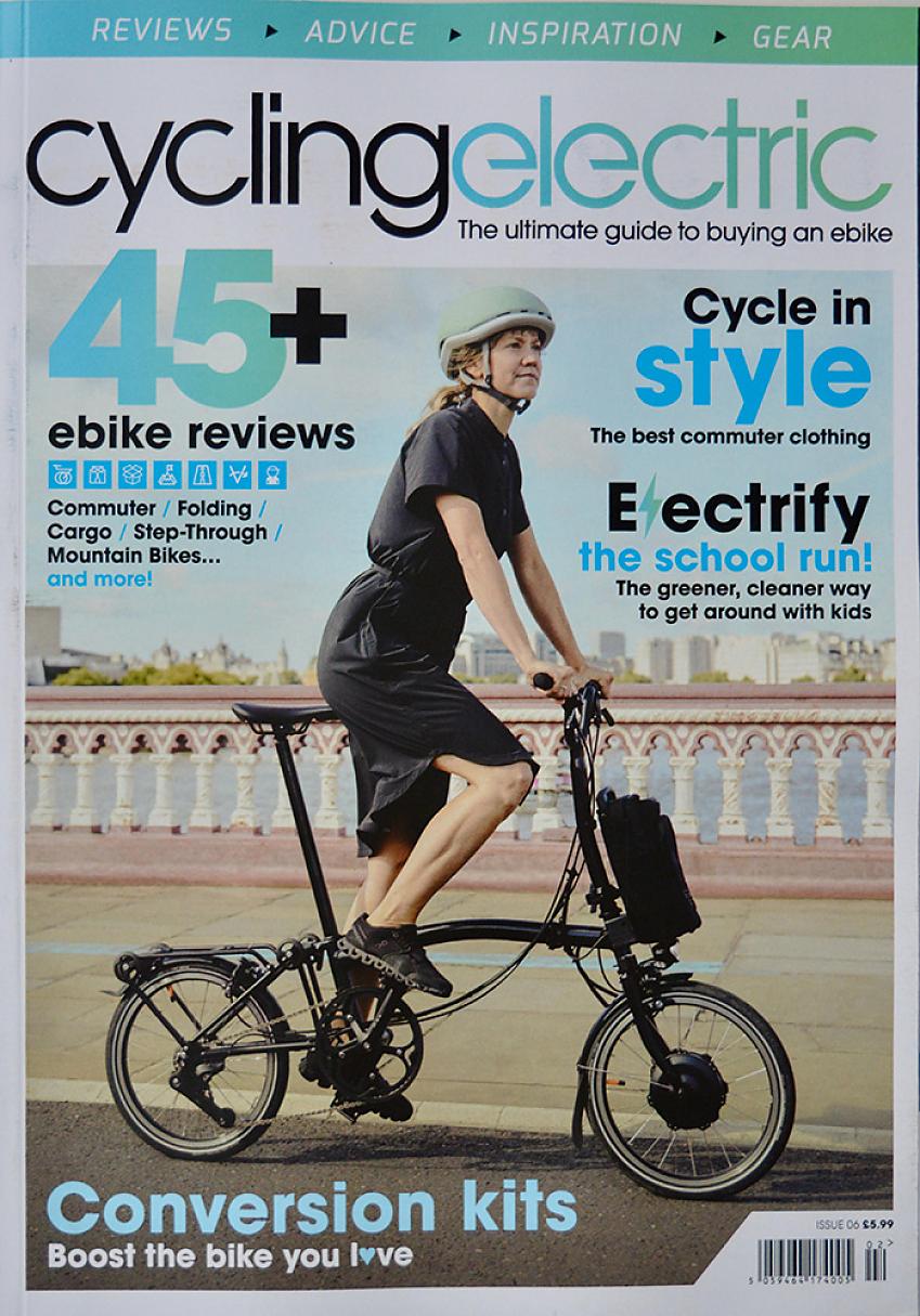 cycling electric issue 6 cover, showing a woman on an electric folding bike cycling along a cycle path next to a river