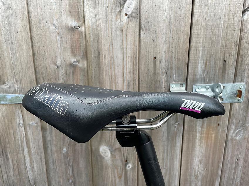 A close-up of a Selle Italia saddle in black and pink