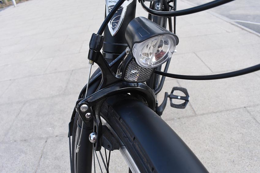 A close-up showing the Trek's front brakes, along with the front light and front fork