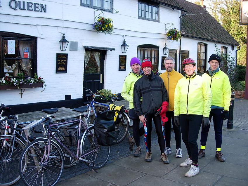 Four male cyclists and their bikes outside a pub