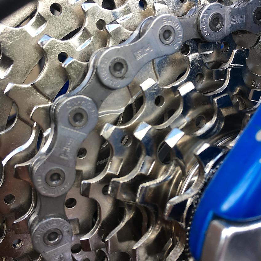 A close-up showing a bike chain and cassette, both in good condition