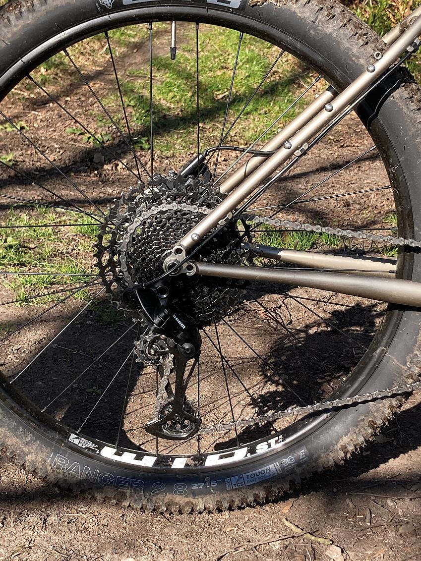 A close-up shot of a mountain bike, showing the rear cassette