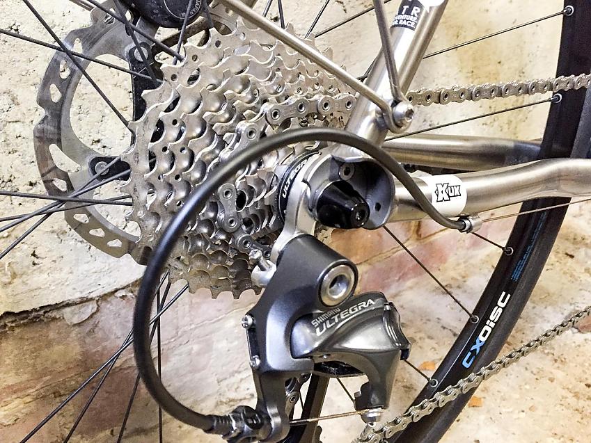 A close-up of the Kinesis Tripster drivechain, showing the cassette, rear derailleur and chain