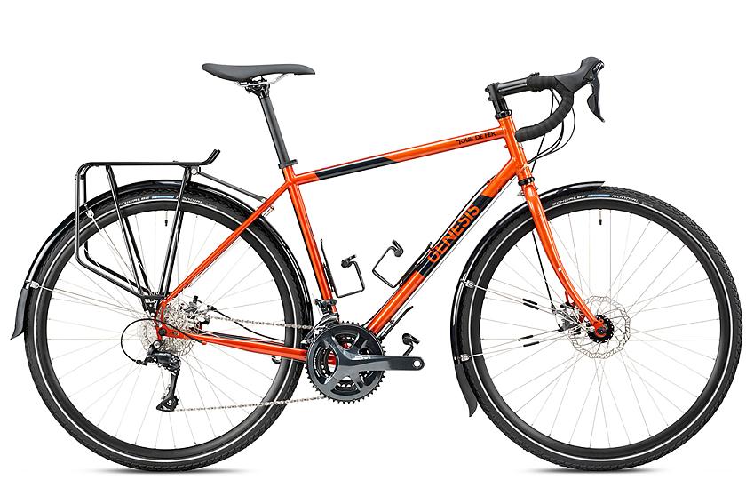 An orange and black touring bike with rear rack and mud guards