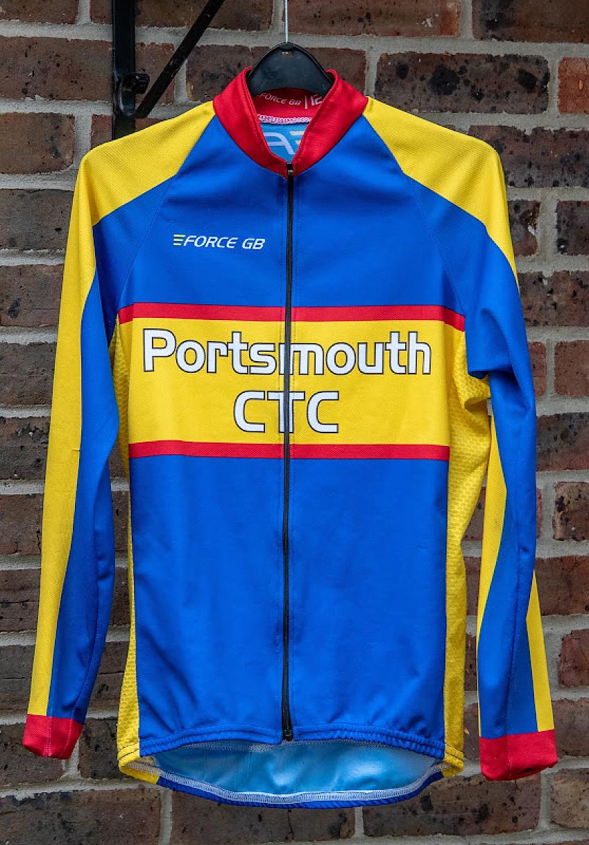 A Portsmouth CTC cycling jersey in the club’s blue and gold colours is hanging against an outside wall
