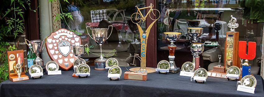 A table displaying many cups, shields and trophies