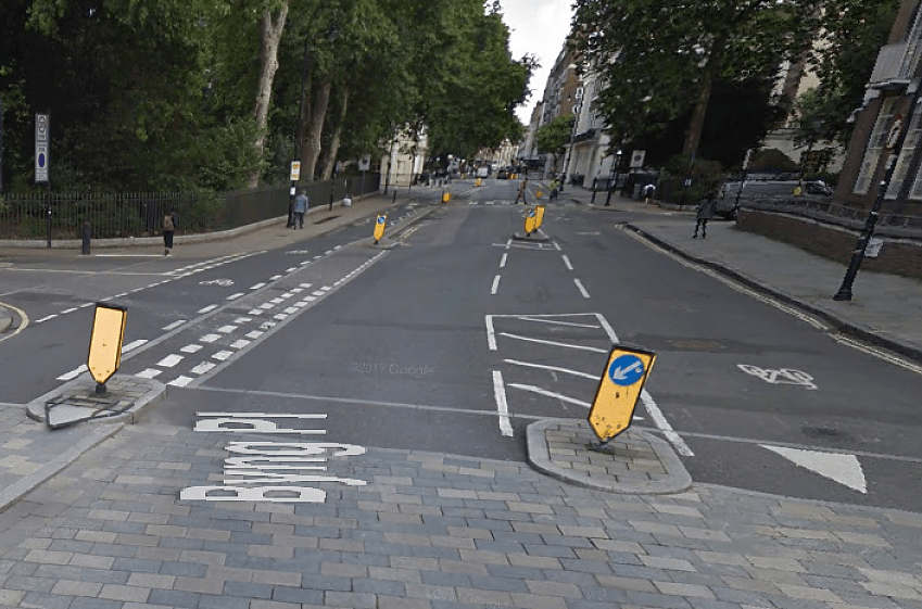 Give-way line for drivers turning into a side road, Torrington Place, London - but it doesn't conform to UK signing rules!