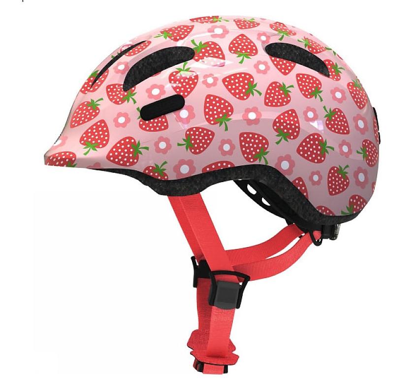 A pink children's cycling helmet with a strawberry and flower pattern