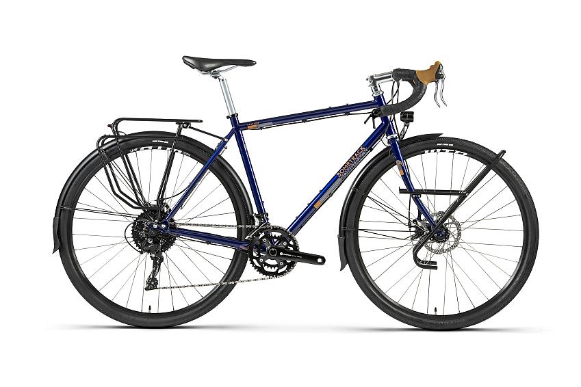 Bombtrack Arise Tour, a dark blue touring bike with drop handlebar, front and rear racks and mudguards