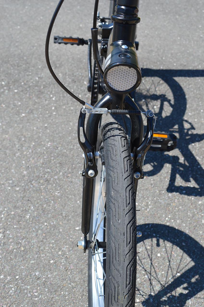 A close-up showing the B'twin's brakes and front fork from the front
