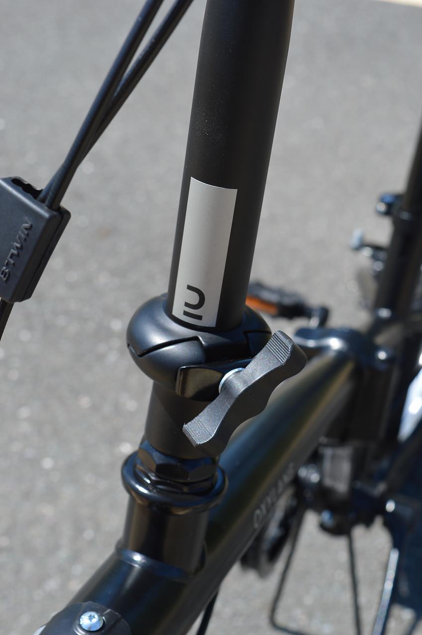A close-up of the B'twin's stem hinge for folding the stem down and lowering the seatpost