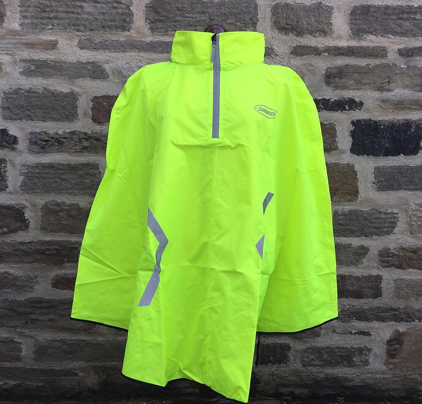 The Carradice Proroute Rain Cape is a bright yellow poncho with reflective highlights