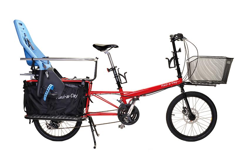 Bike Friday Haul-A-Day, red folding cargo bike with a front basket, child seat and rear panniers
