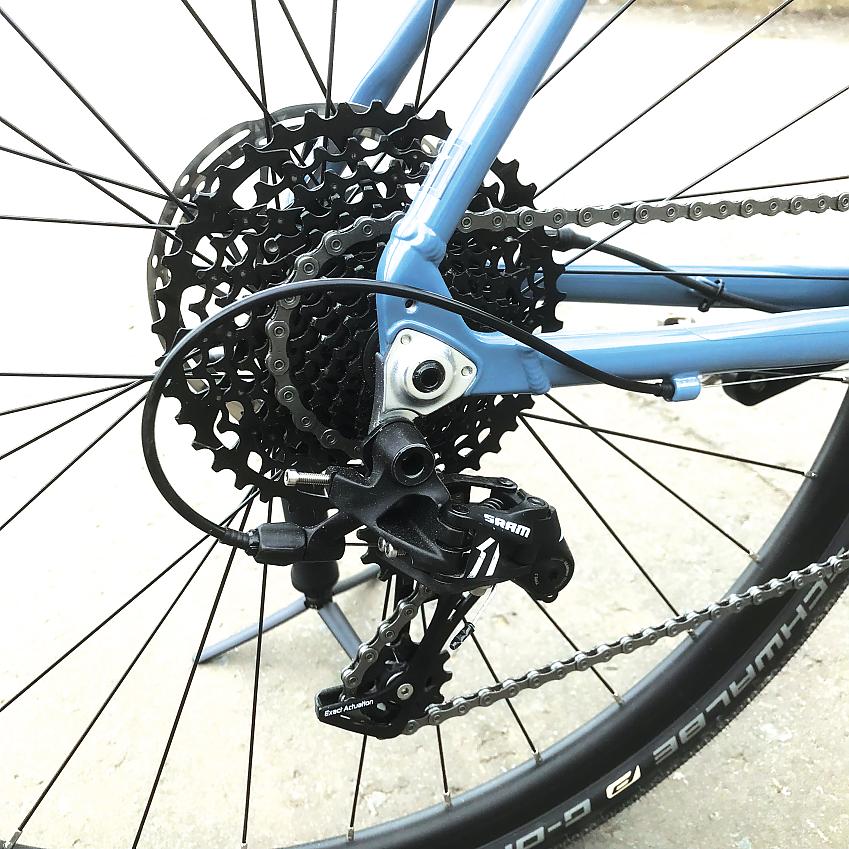 A close-up of the Kinesis G2's back wheel showing the cassette, chain, rear derailleur
