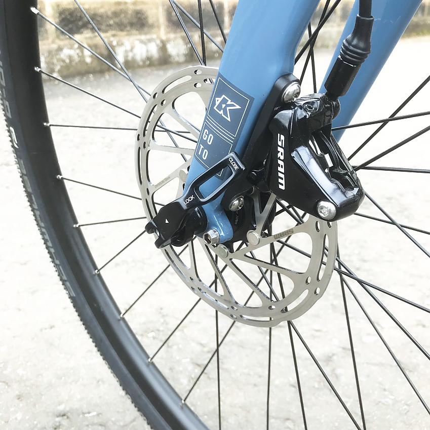 A close-up of the Kinesis G2's front wheel showing the hub, disc brakes and quick release mechanism
