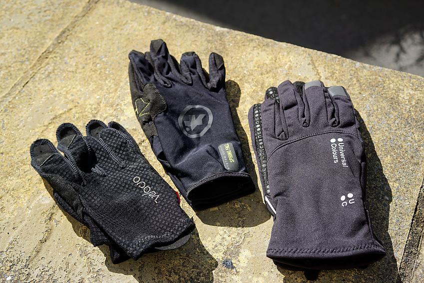 Three different cycling gloves in black. They all have long fingers and are quite thin