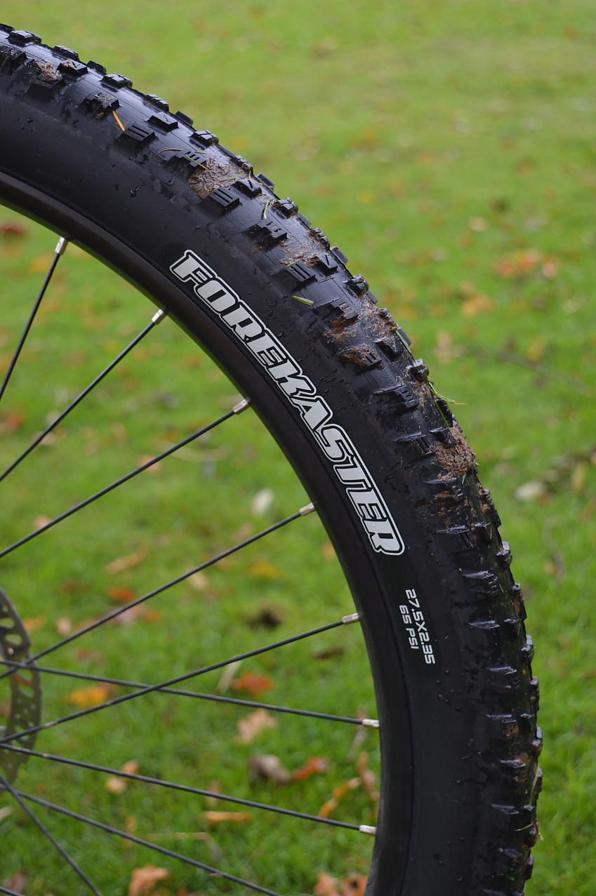 A close-up of a mountain bike wheel and tyre, showing the brand name, Forekaster