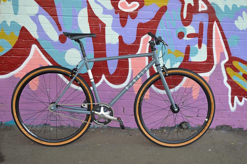 Ribble Urban 725s, a grey fixed wheel bike leaning against a wall covered in bright grafitti