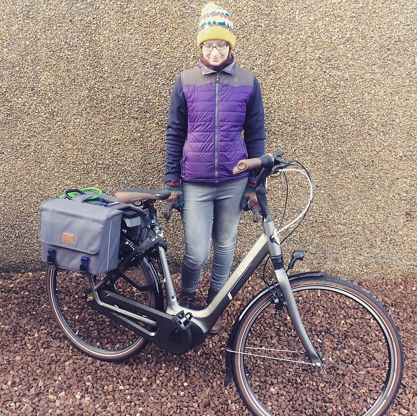 Claire gives her borrowed electric bike a loving look