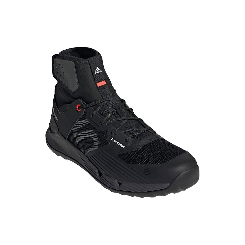 An Adidas Five Ten Trailcross GTX shoe. It's black with the Adidas logo on it and couple of orange highlights. It's got quite high ankle support
