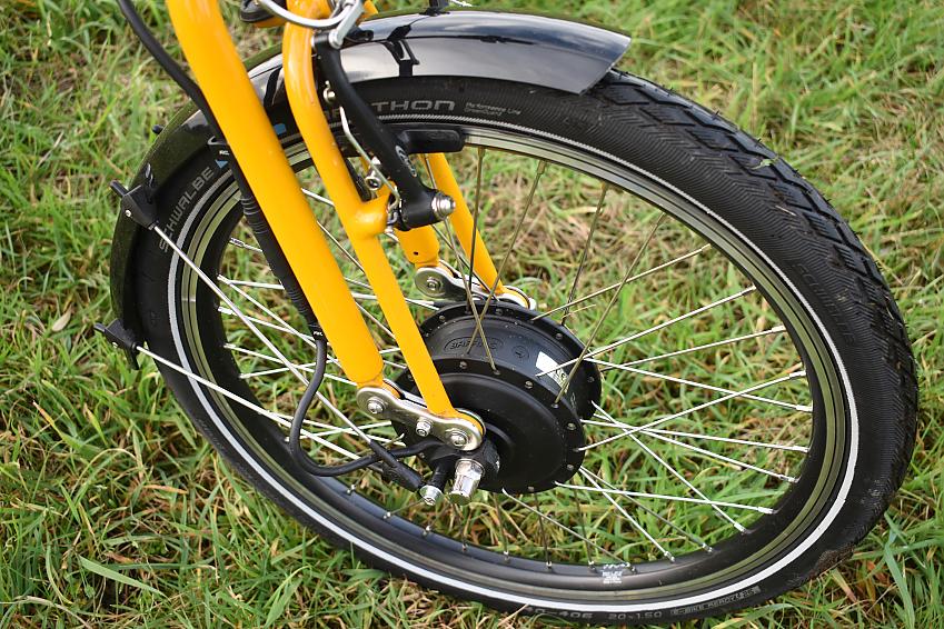 A close-up of the Moulton's front wheel, showing the hub and fork