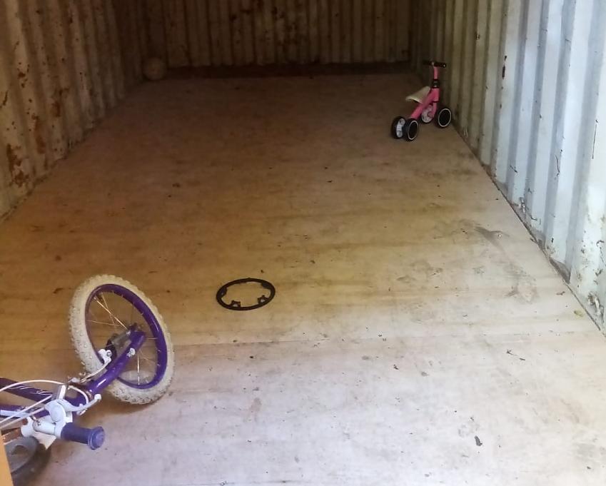 A storage container with two child's bikes inside