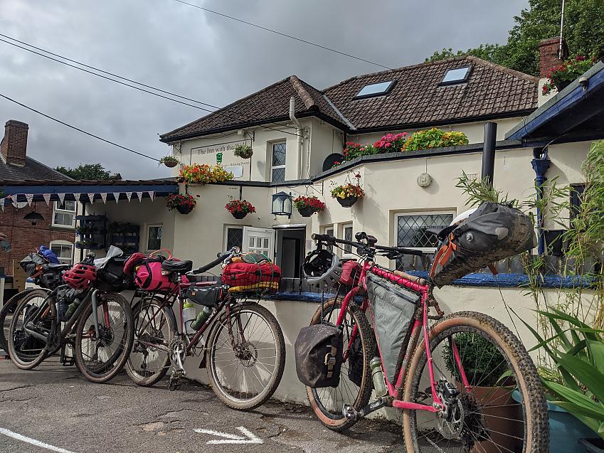 A selection of different bikes and their styles of packing lined up outside a pub